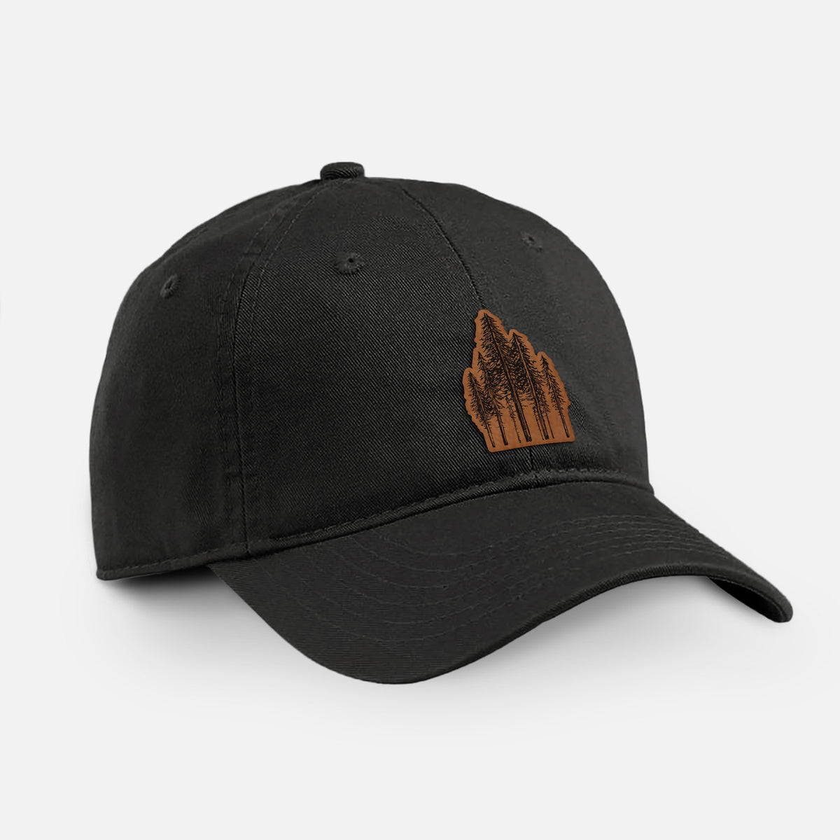 Black cotton baseball hat with a black ink illustration of a stand of tall coastal redwood trees with slender trunks and layered branches on the front.
