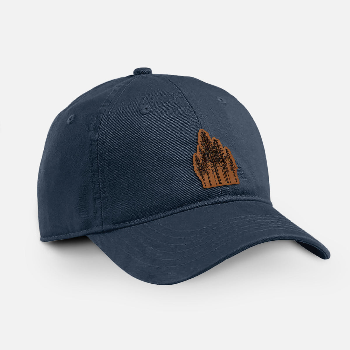 Navy cotton baseball hat with a black ink illustration of a stand of tall coastal redwood trees with slender trunks and layered branches on the front.