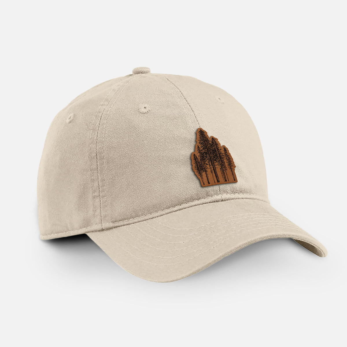 Stone cotton baseball hat with a black ink illustration of a stand of tall coastal redwood trees with slender trunks and layered branches on the front.