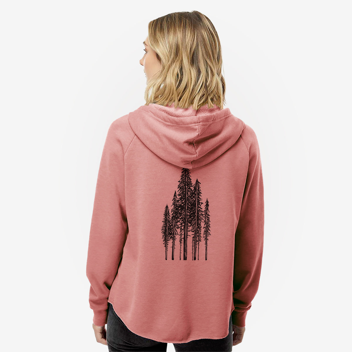 Woman wearing a dusty rose women's Cali Wave zip-up sweatshirt printed with a black ink illustration of a stand of tall coastal redwood trees with slender trunks and layered branches, seen from behind.