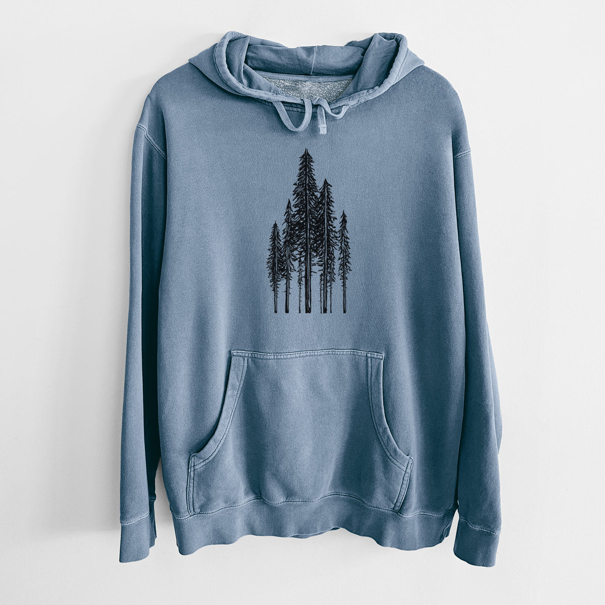 Slate blue pigment dyed hoodie laid flat, printed with a black ink illustration of a stand of tall coastal redwood trees with slender trunks and layered branches.