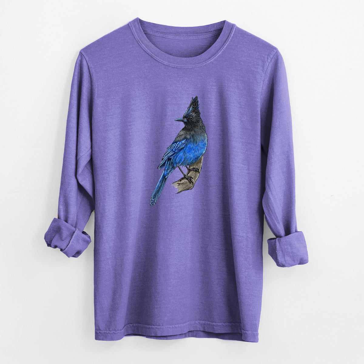 Violet purple Comfort Colors long sleeve shirt laid flat with the cuffs rolled, printed with a full-color illustration of a Steller's jay perched with its dark crest raised.