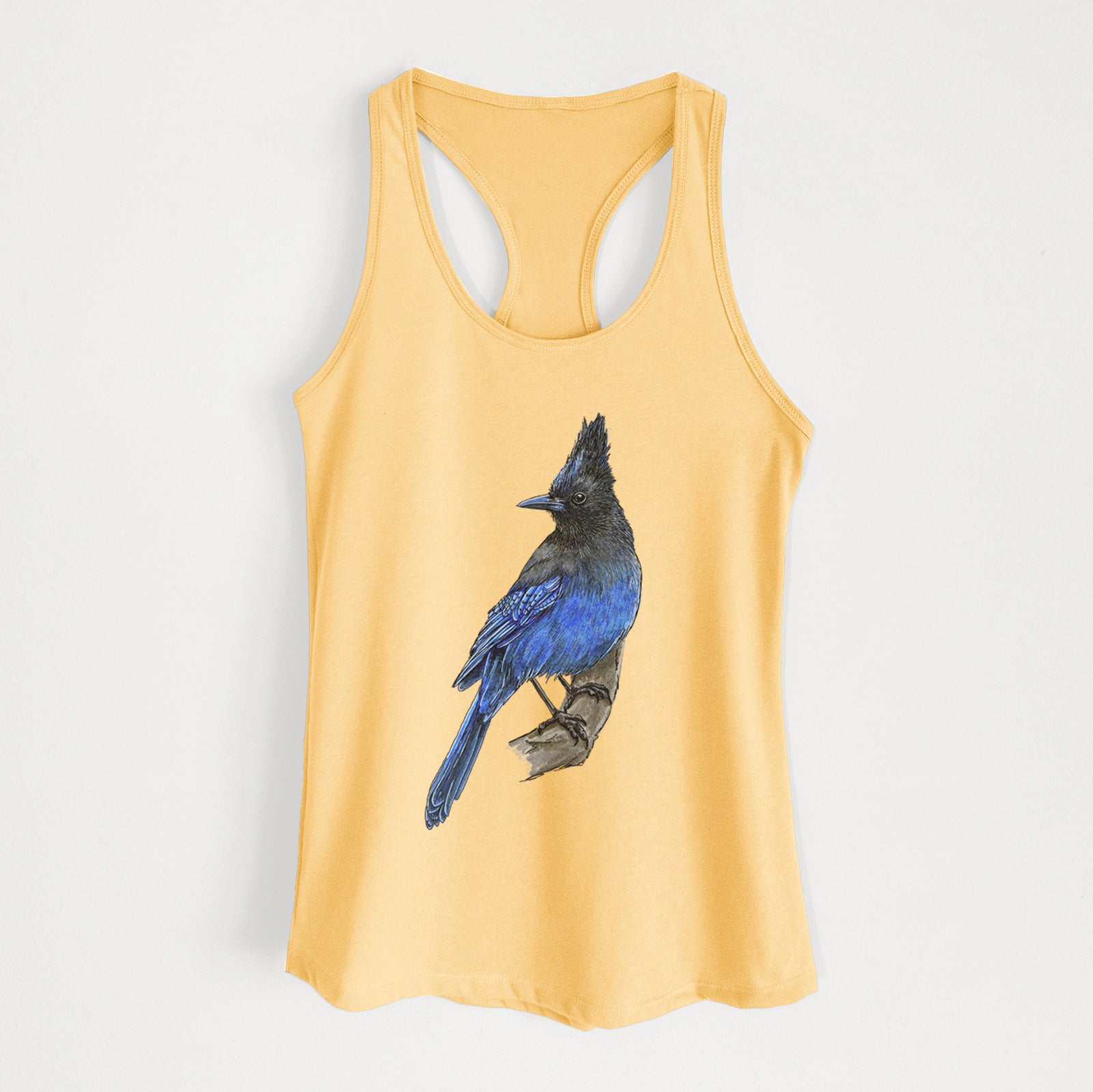 Banana cream women's racerback tank top laid flat, printed with a full-color illustration of a Steller's jay perched with its dark crest raised.