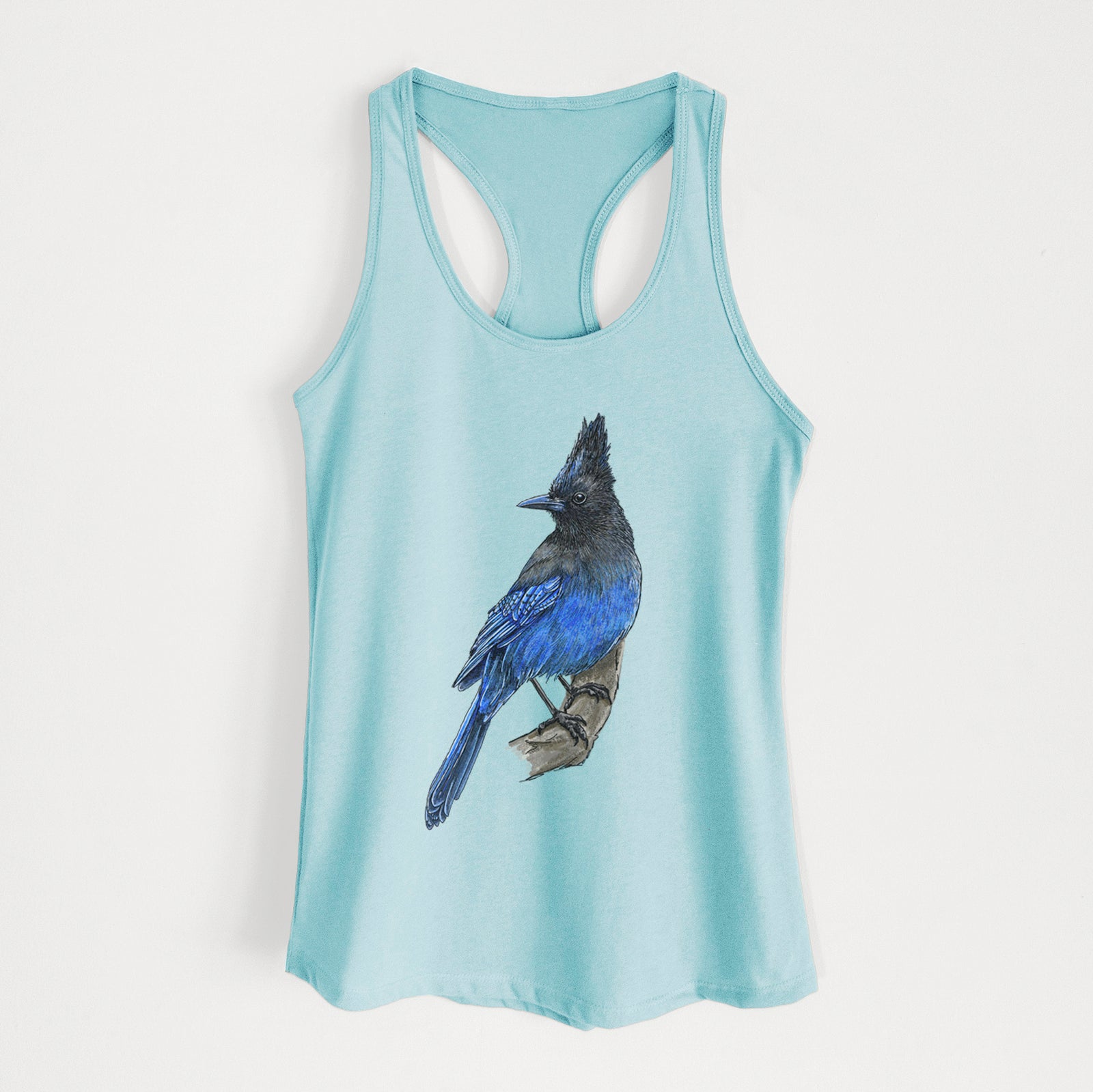 Banana cream women's racerback tank top laid flat, printed with a full-color illustration of a Steller's jay perched with its dark crest raised.