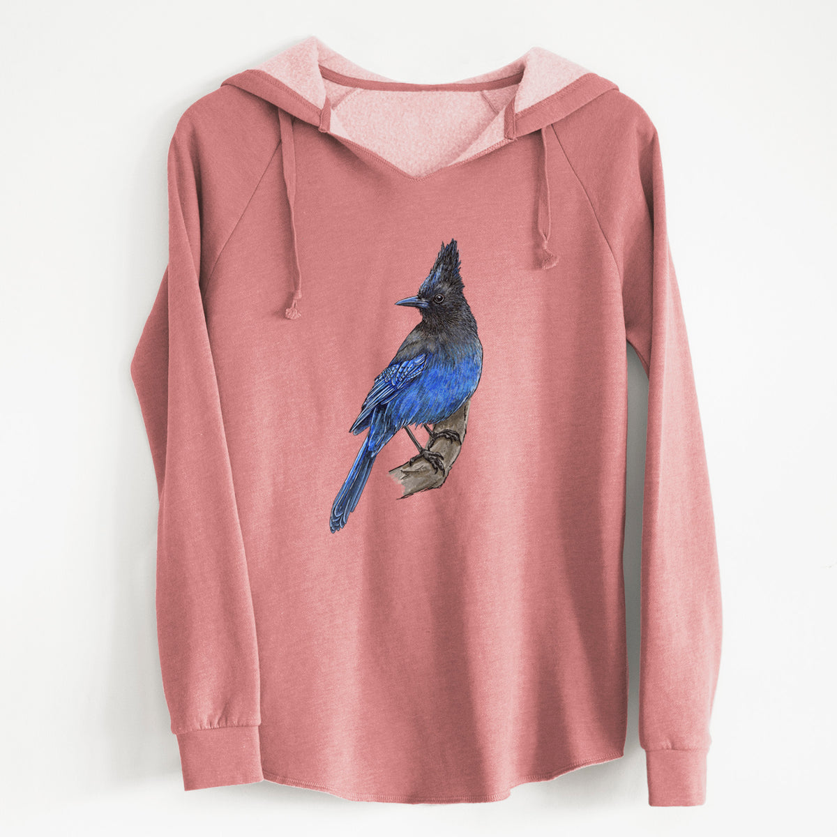 Dusty rose women's Cali Wave hooded sweatshirt laid flat, printed with a full-color illustration of a Steller's jay perched with its dark crest raised.