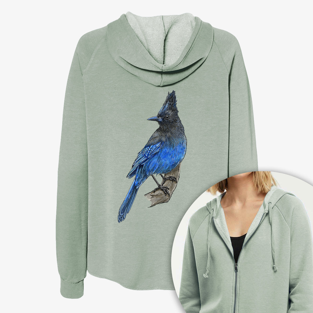 Women's Cali Wave zip-up sweatshirt printed with a full-color illustration of a Steller's jay perched with its dark crest raised, with a close-up of the zipper.