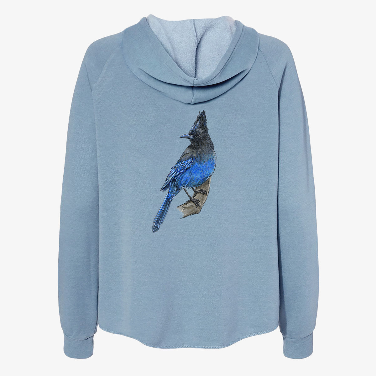 Misty blue women's Cali Wave zip-up sweatshirt laid flat, printed with a full-color illustration of a Steller's jay perched with its dark crest raised.