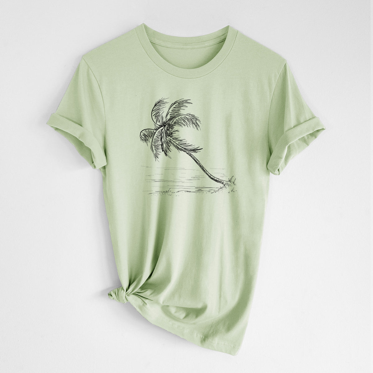Spring green lightweight cotton t-shirt laid flat with the sleeves rolled, printed with a black ink illustration of a coconut palm leaning over a sandy beach.
