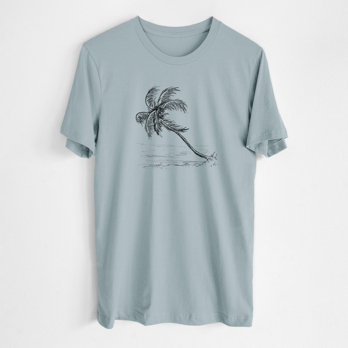 Vintage denim lightweight cotton t-shirt laid flat, printed with a black ink illustration of a coconut palm leaning over a sandy beach.