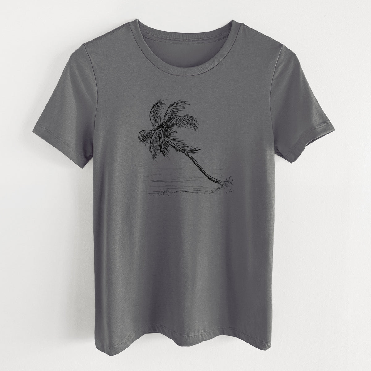 Asphalt women's relaxed fit cotton t-shirt laid flat, printed with a black ink illustration of a coconut palm leaning over a sandy beach.