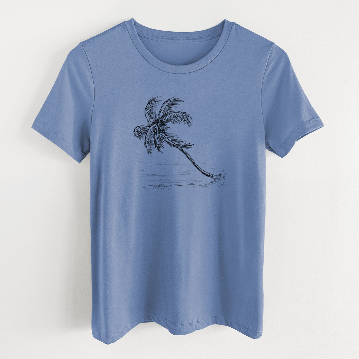 Blue bell women's relaxed fit cotton t-shirt laid flat, printed with a black ink illustration of a coconut palm leaning over a sandy beach.