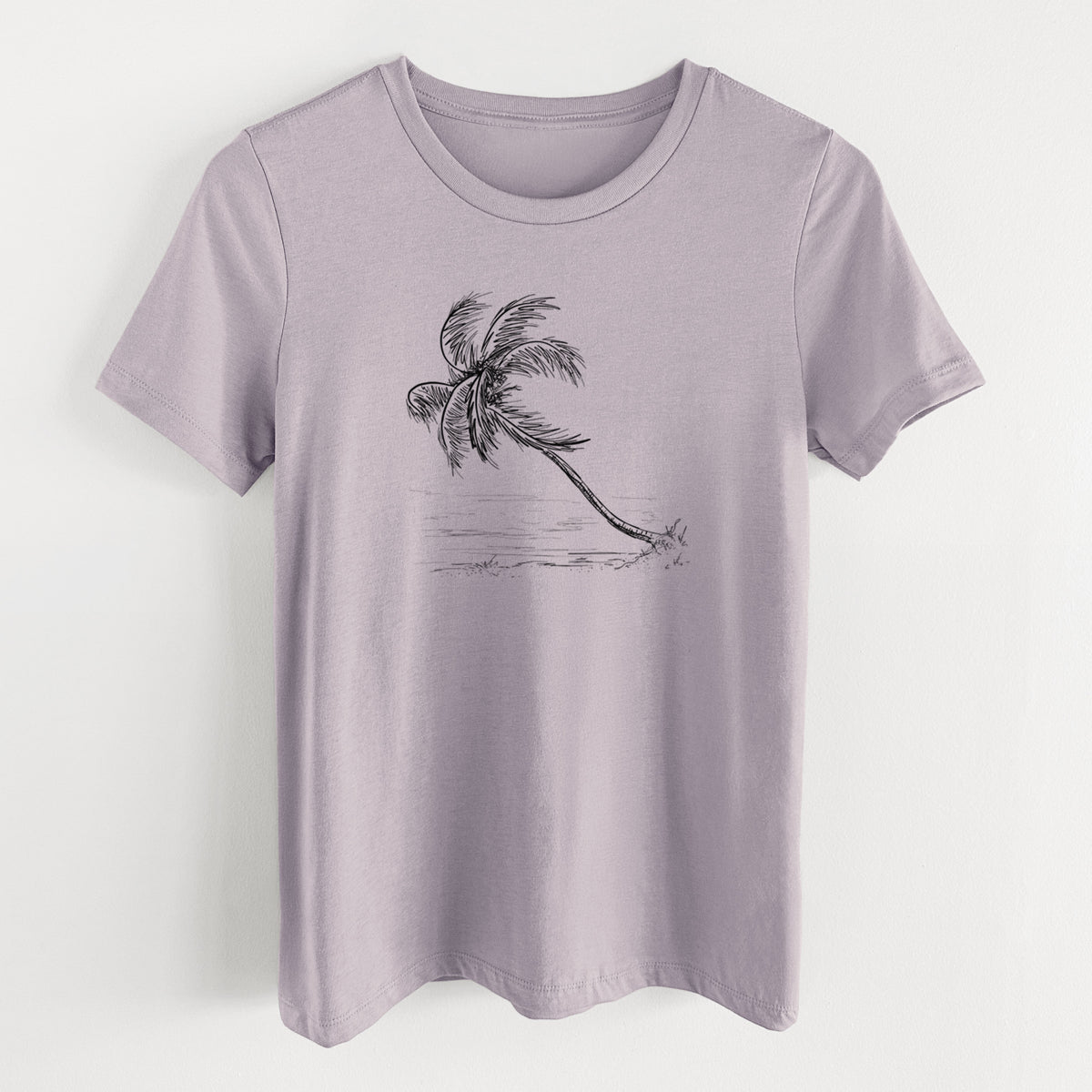 Light violet women's relaxed fit cotton t-shirt laid flat, printed with a black ink illustration of a coconut palm leaning over a sandy beach.