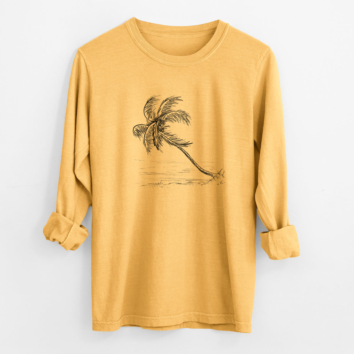 Golden wheat yellow Comfort Colors long sleeve shirt laid flat with the cuffs rolled, printed with a black ink illustration of a coconut palm leaning over a sandy beach.