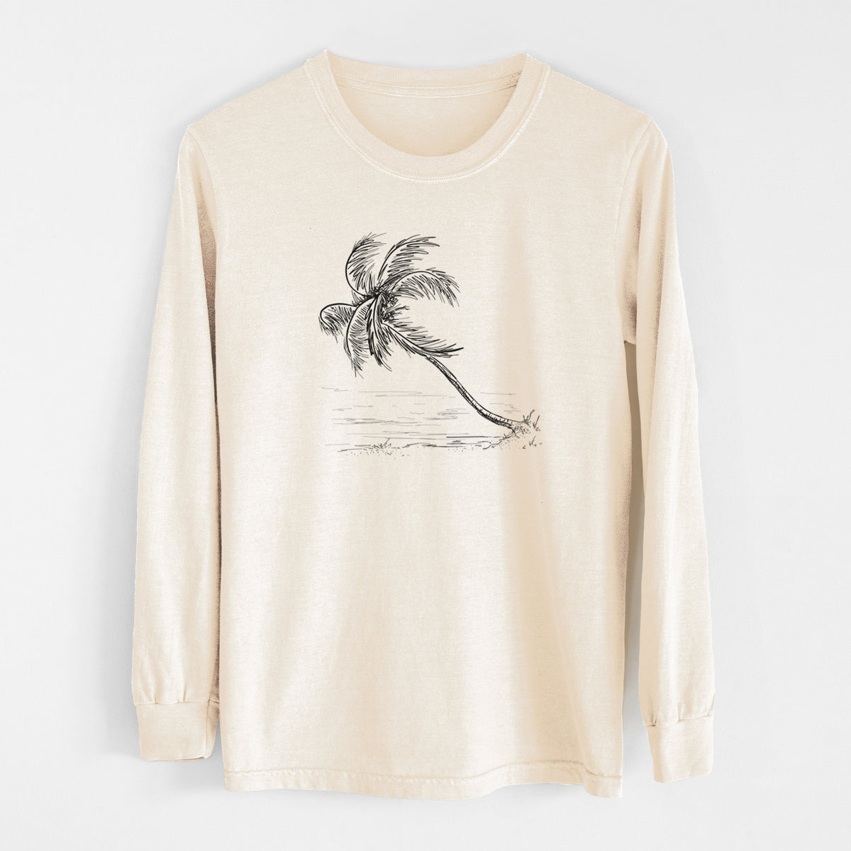 Ivory Comfort Colors long sleeve shirt laid flat, printed with a black ink illustration of a coconut palm leaning over a sandy beach.