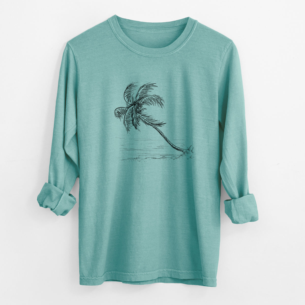 Reef green Comfort Colors long sleeve shirt laid flat with the cuffs rolled, printed with a black ink illustration of a coconut palm leaning over a sandy beach.
