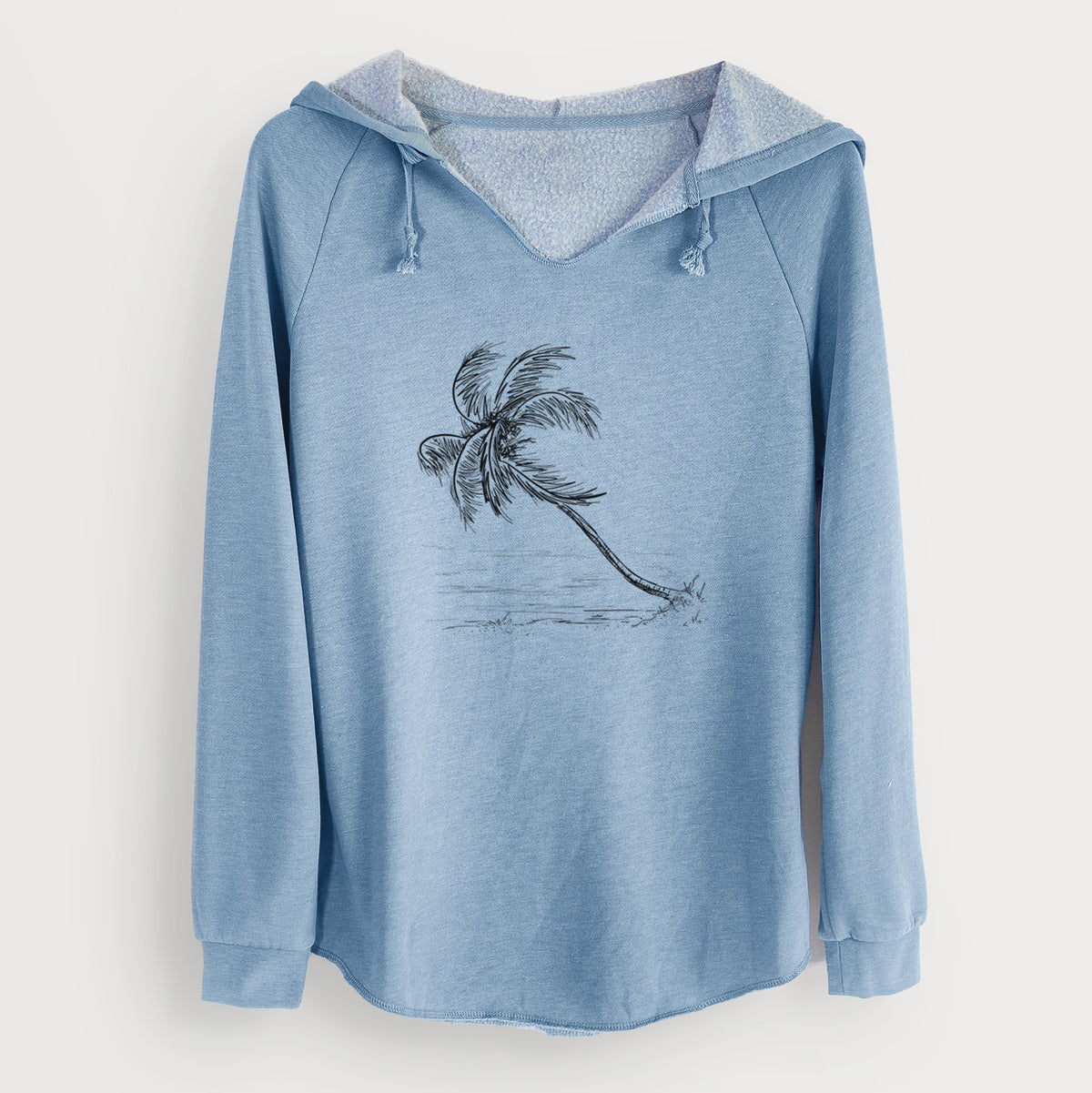 Misty blue women's Cali Wave hooded sweatshirt laid flat, printed with a black ink illustration of a coconut palm leaning over a sandy beach.