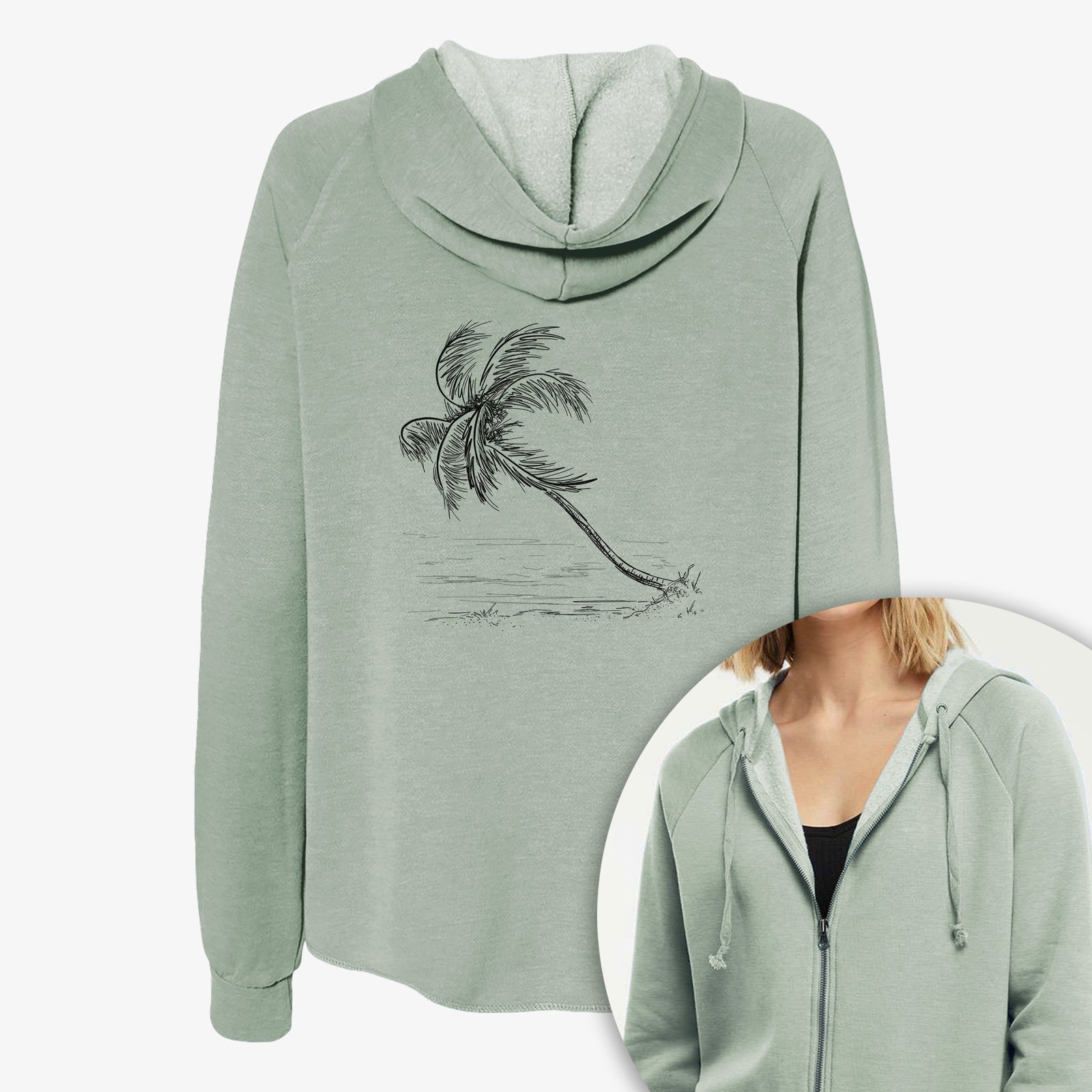 Women's Cali Wave zip-up sweatshirt printed with a black ink illustration of a coconut palm leaning over a sandy beach, with a close-up of the zipper.
