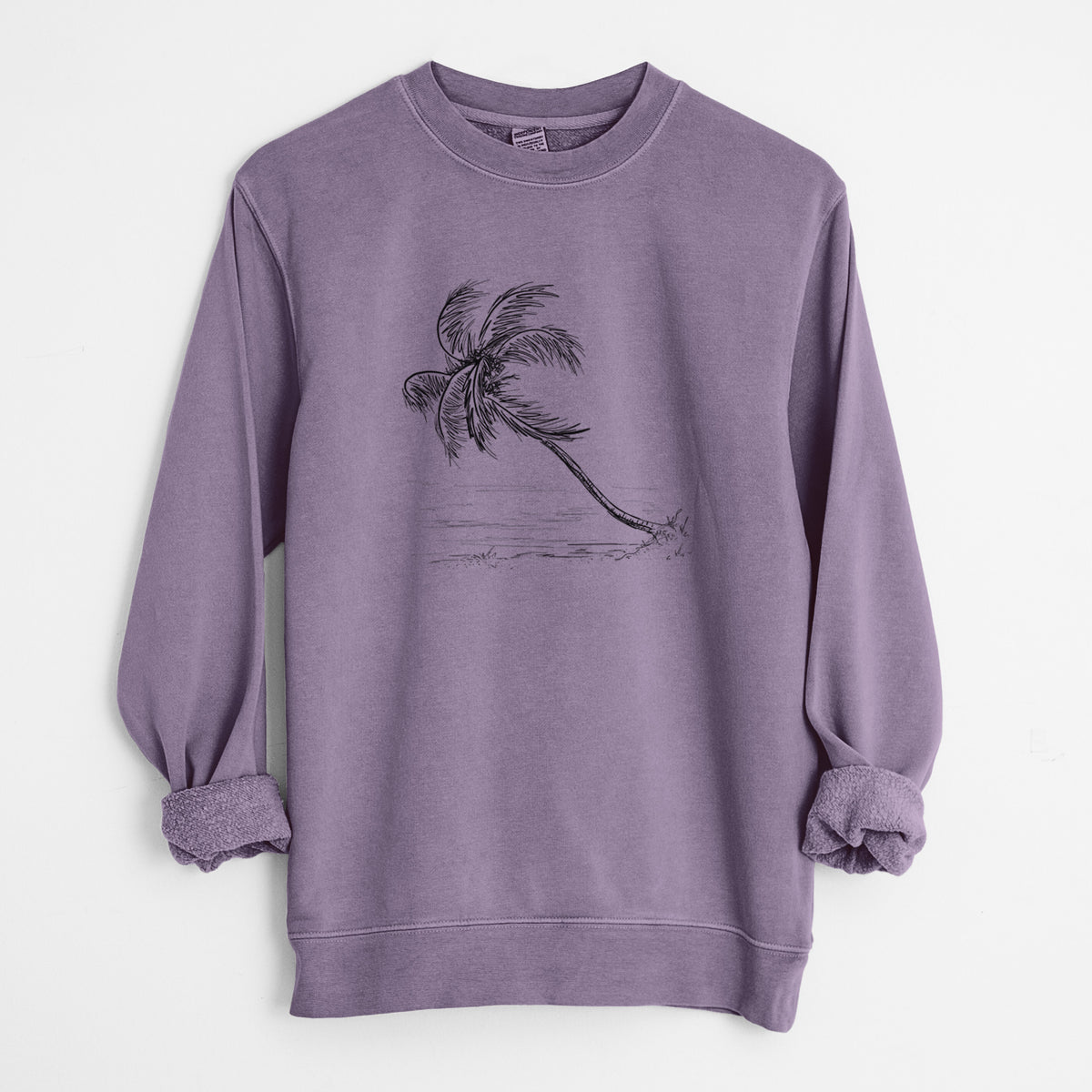 Plum purple pigment dyed crewneck sweatshirt laid flat with the sleeves rolled, printed with a black ink illustration of a coconut palm leaning over a sandy beach.