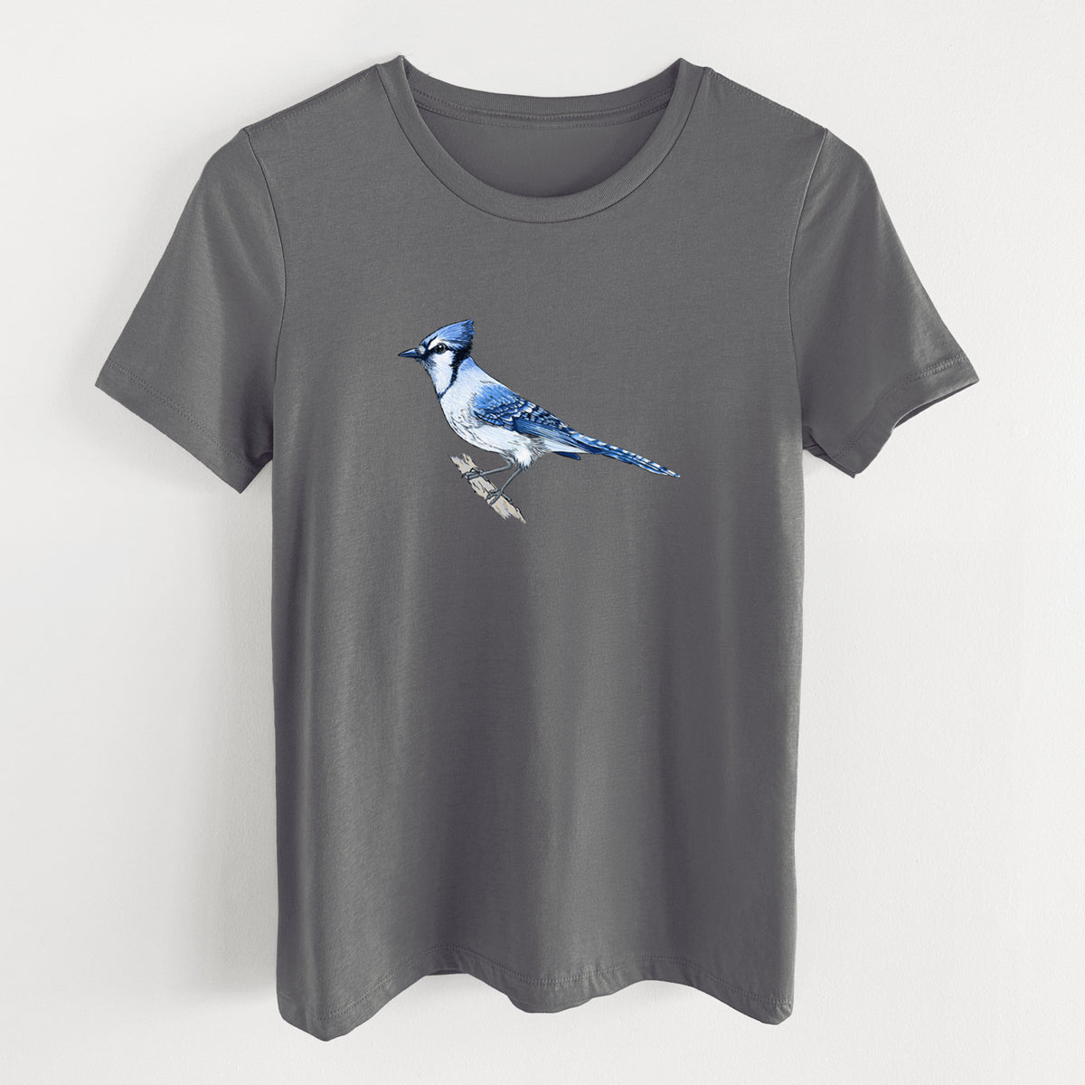 Asphalt women's relaxed fit cotton t-shirt laid flat, printed with a full-color illustration of a blue jay perched on a branch.