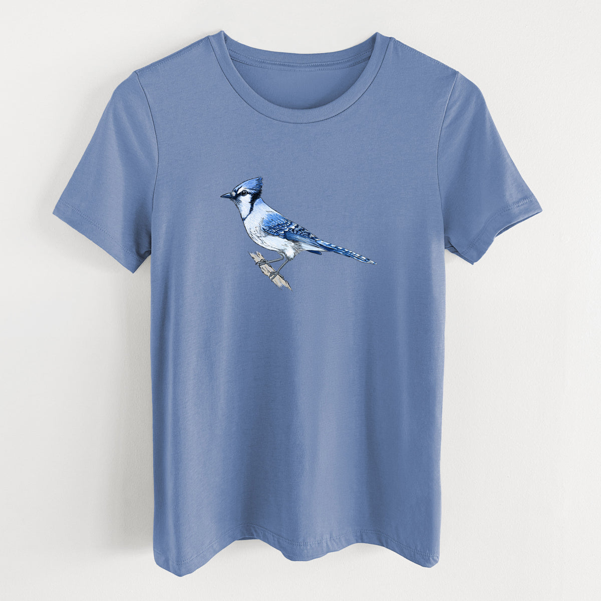 Blue bell women's relaxed fit cotton t-shirt laid flat, printed with a full-color illustration of a blue jay perched on a branch.