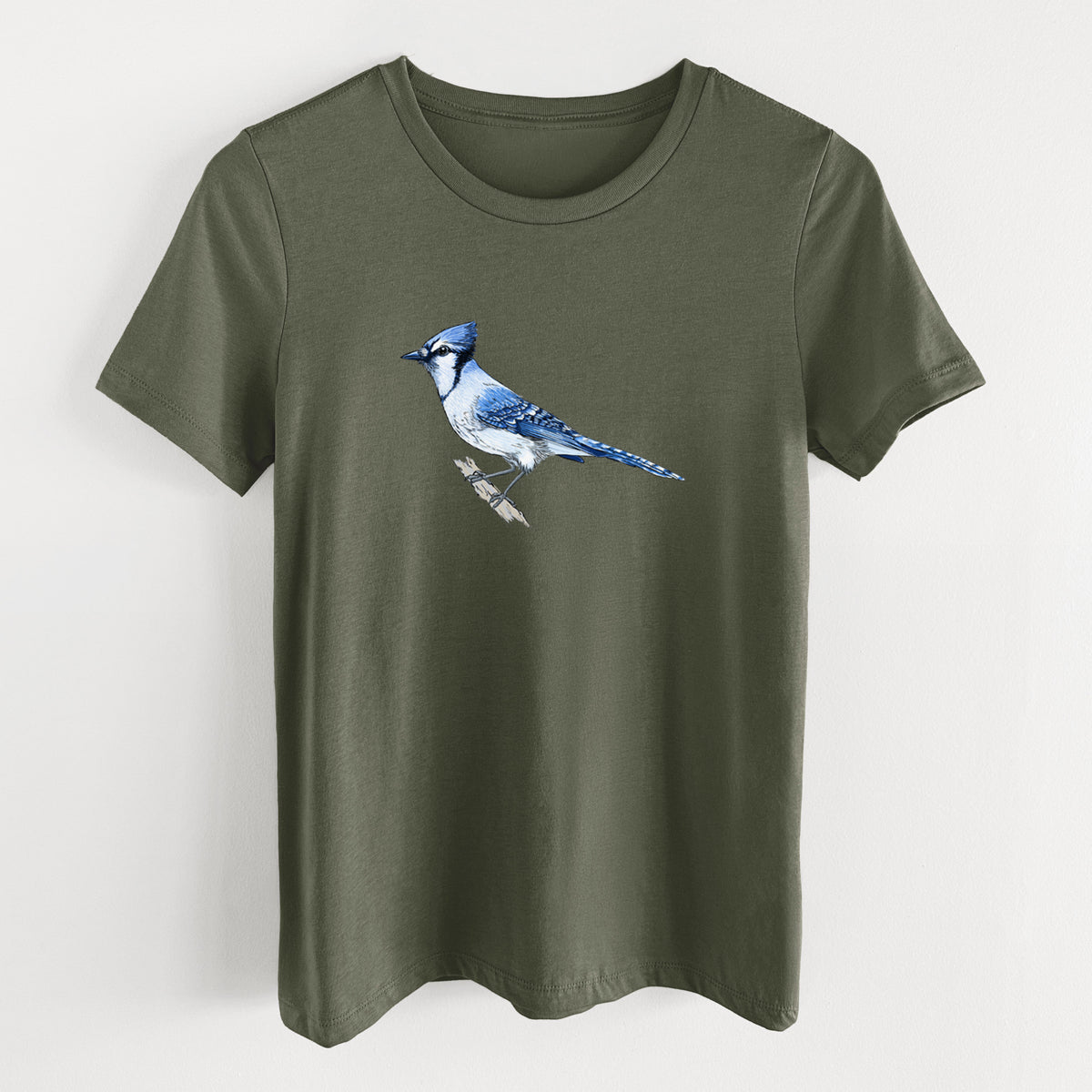 Military green women's relaxed fit cotton t-shirt laid flat, printed with a full-color illustration of a blue jay perched on a branch.