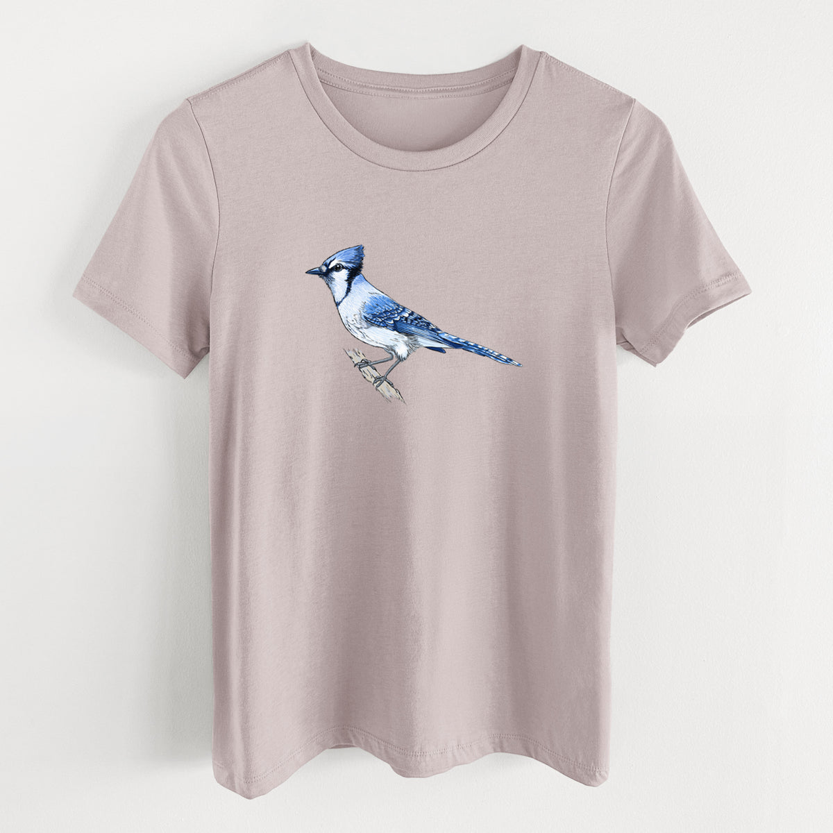 Pink gravel women's relaxed fit cotton t-shirt laid flat, printed with a full-color illustration of a blue jay perched on a branch.