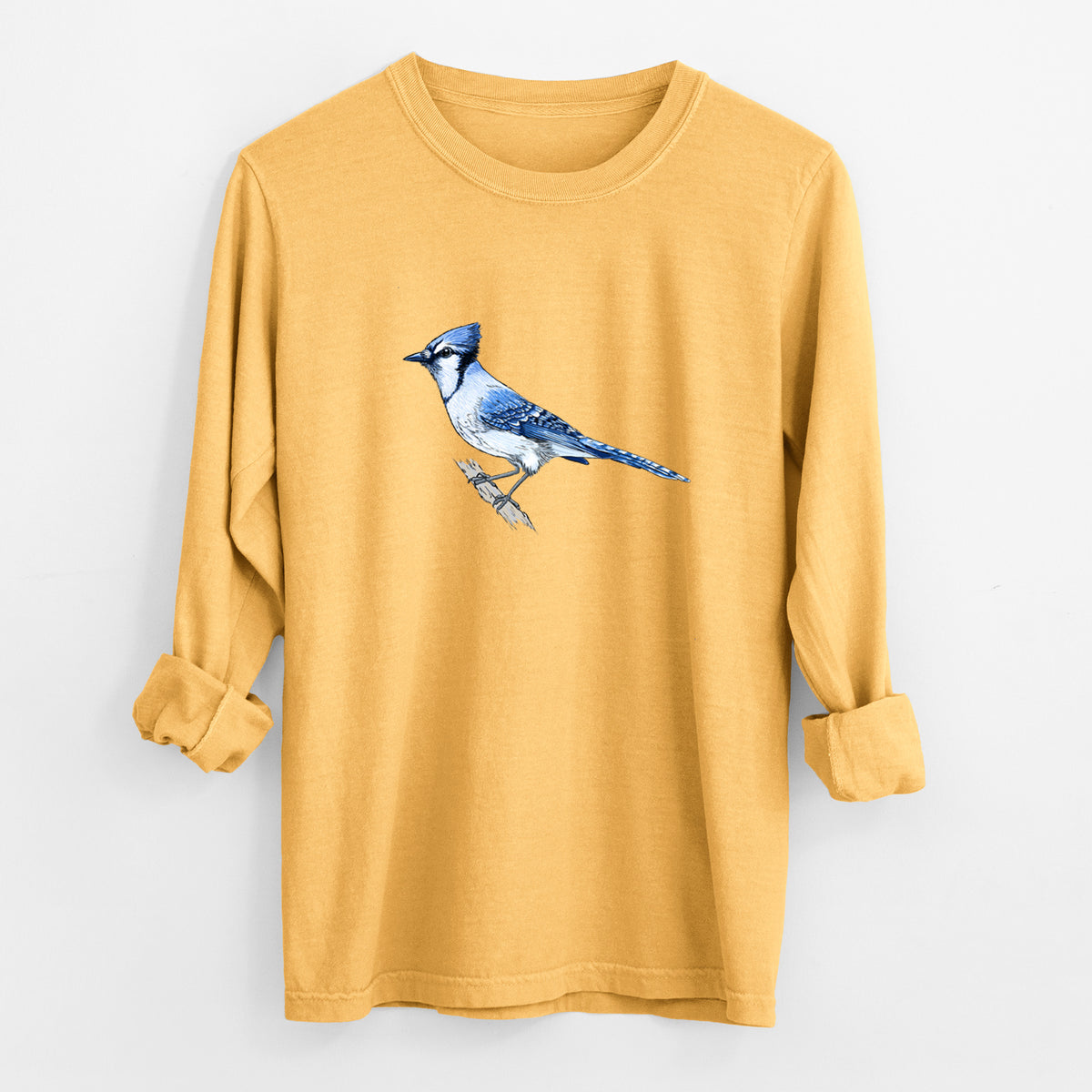 Golden wheat yellow Comfort Colors long sleeve shirt laid flat with the cuffs rolled, printed with a full-color illustration of a blue jay perched on a branch.