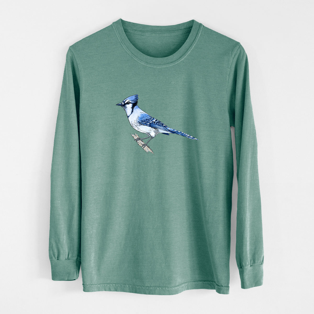 Pine green Comfort Colors long sleeve shirt laid flat, printed with a full-color illustration of a blue jay perched on a branch.