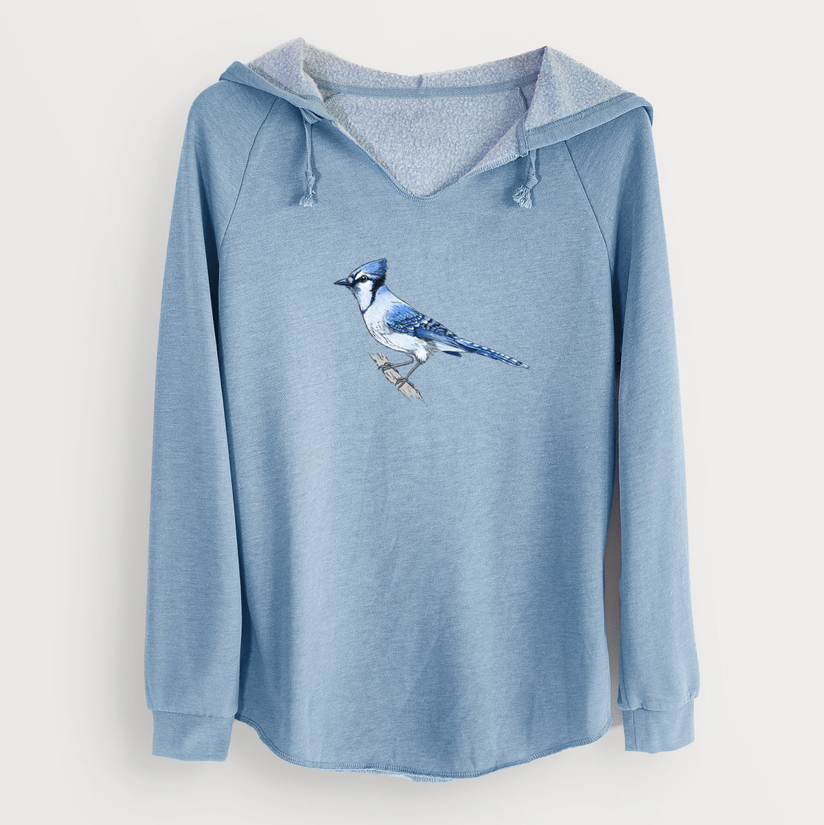 Misty blue women's Cali Wave hooded sweatshirt laid flat, printed with a full-color illustration of a blue jay perched on a branch.
