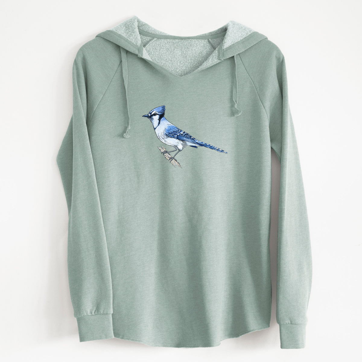 Sage green women's Cali Wave hooded sweatshirt laid flat, printed with a full-color illustration of a blue jay perched on a branch.