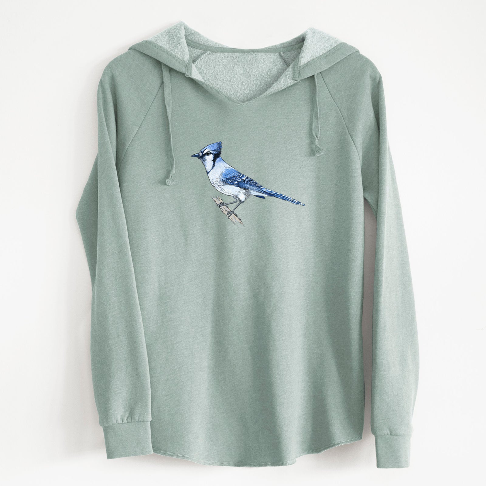 Sage green women's Cali Wave hooded sweatshirt laid flat, printed with a full-color illustration of a blue jay perched on a branch.