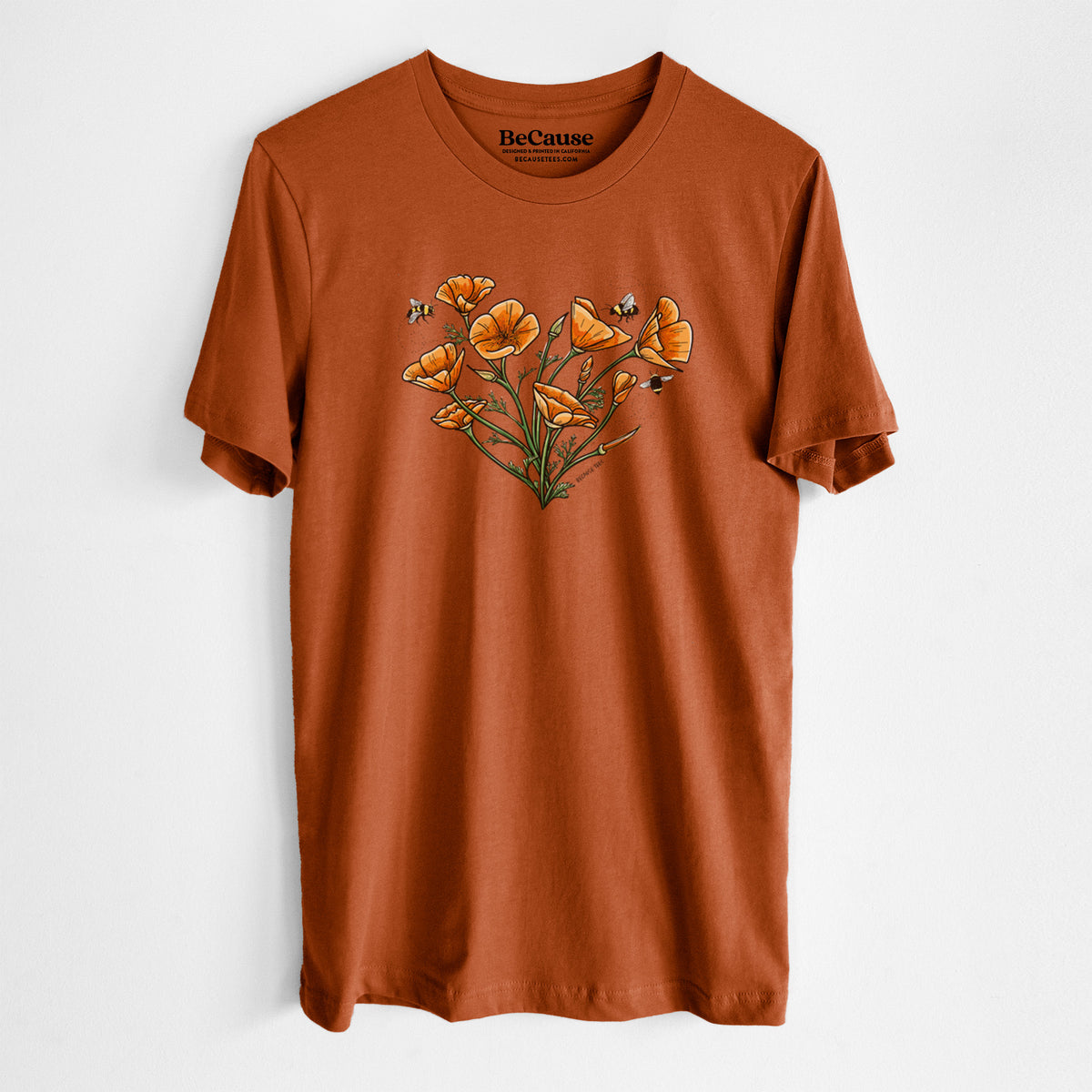 Autumn lightweight cotton t-shirt laid flat, printed with a full-color bouquet of orange California poppies arranged in a heart shape, with small bees.
