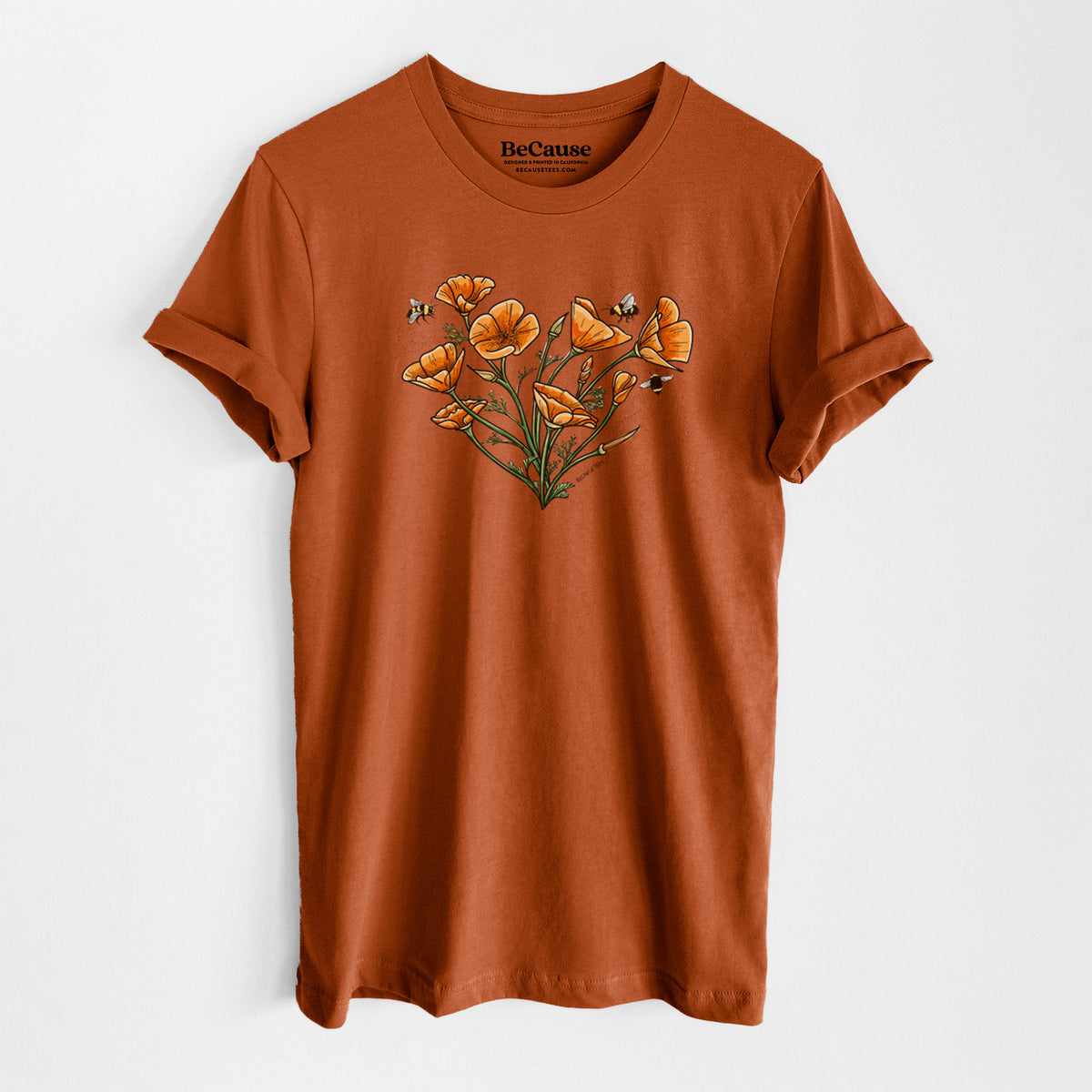 Autumn lightweight cotton t-shirt laid flat, printed with a full-color bouquet of orange California poppies arranged in a heart shape, with small bees.