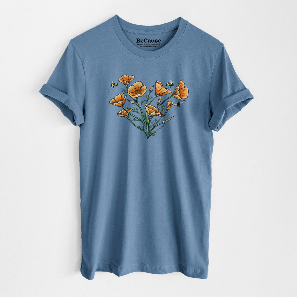 Steel blue lightweight cotton t-shirt laid flat, printed with a full-color bouquet of orange California poppies arranged in a heart shape, with small bees.