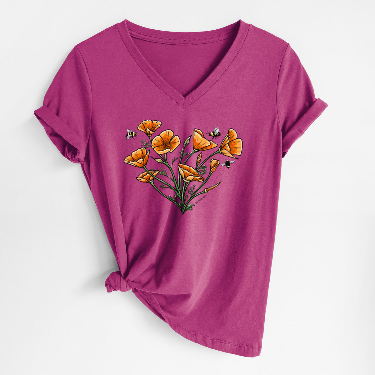 Berry pink women's relaxed fit cotton V-neck t-shirt laid flat, printed with a full-color bouquet of orange California poppies arranged in a heart shape, with small bees.