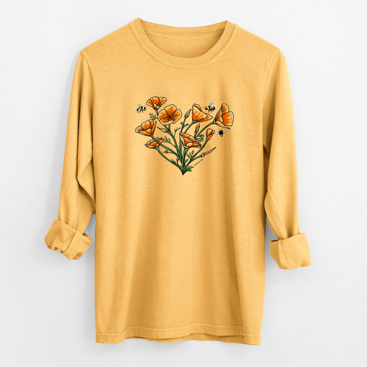 Golden wheat yellow Comfort Colors long sleeve shirt laid flat with the cuffs rolled, printed with a full-color bouquet of orange California poppies arranged in a heart shape, with small bees.