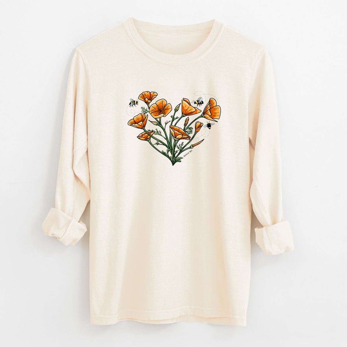 Ivory Comfort Colors long sleeve shirt laid flat with the cuffs rolled, printed with a full-color bouquet of orange California poppies arranged in a heart shape, with small bees.
