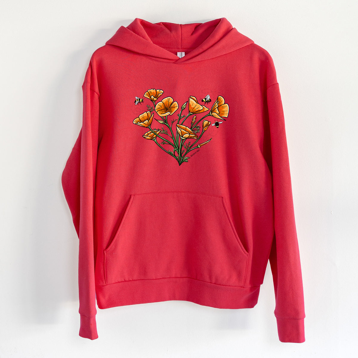 Color California Poppy Heart - Statement Midweight Hoodie in Cherry Red, hanging on a white wall, with a front kangaroo pocket and no drawcords.