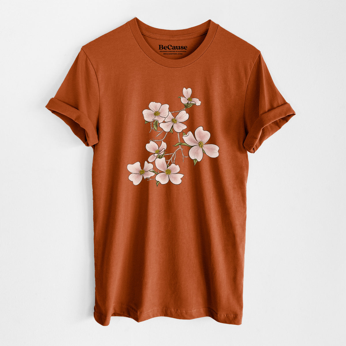 Autumn lightweight cotton t-shirt laid flat, printed with a full-color illustration of pink and white dogwood blossoms on a branch.