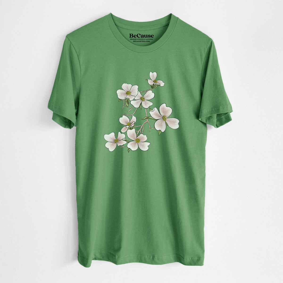 Leaf green lightweight cotton t-shirt laid flat, printed with a full-color illustration of pink and white dogwood blossoms on a branch.