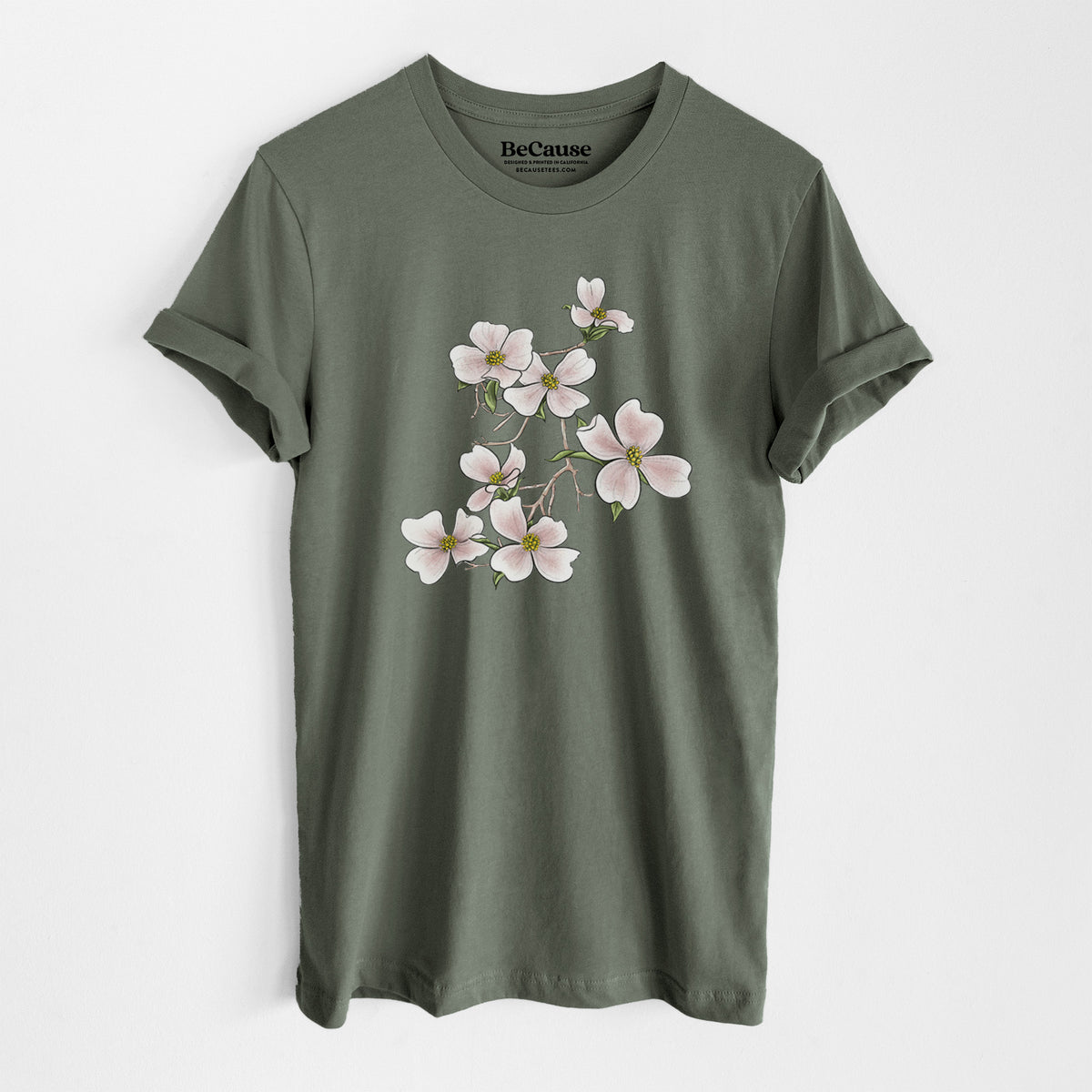 Military green lightweight cotton t-shirt laid flat, printed with a full-color illustration of pink and white dogwood blossoms on a branch.