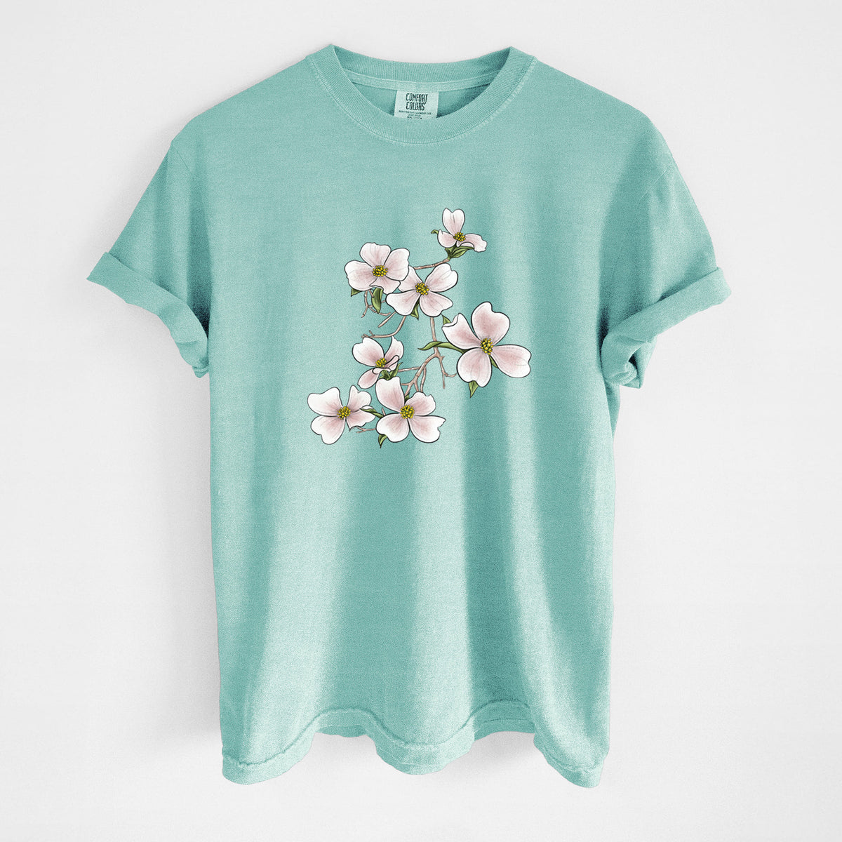 Chalky mint Comfort Colors t-shirt laid flat, printed with a full-color illustration of pink and white dogwood blossoms on a branch.