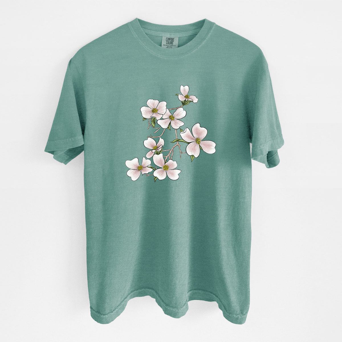 Reef green Comfort Colors t-shirt laid flat, printed with a full-color illustration of pink and white dogwood blossoms on a branch.