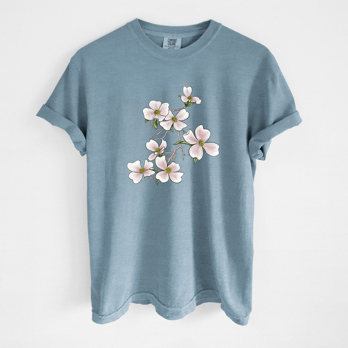 Steel blue Comfort Colors t-shirt laid flat, printed with a full-color illustration of pink and white dogwood blossoms on a branch.