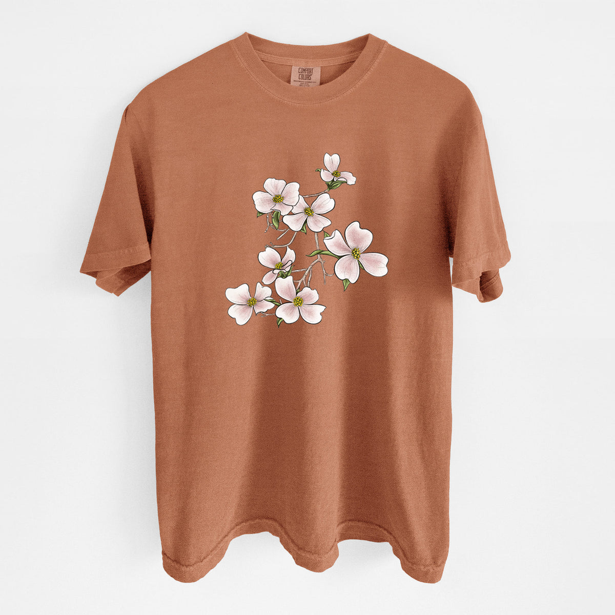 Yam burnt orange Comfort Colors t-shirt laid flat, printed with a full-color illustration of pink and white dogwood blossoms on a branch.