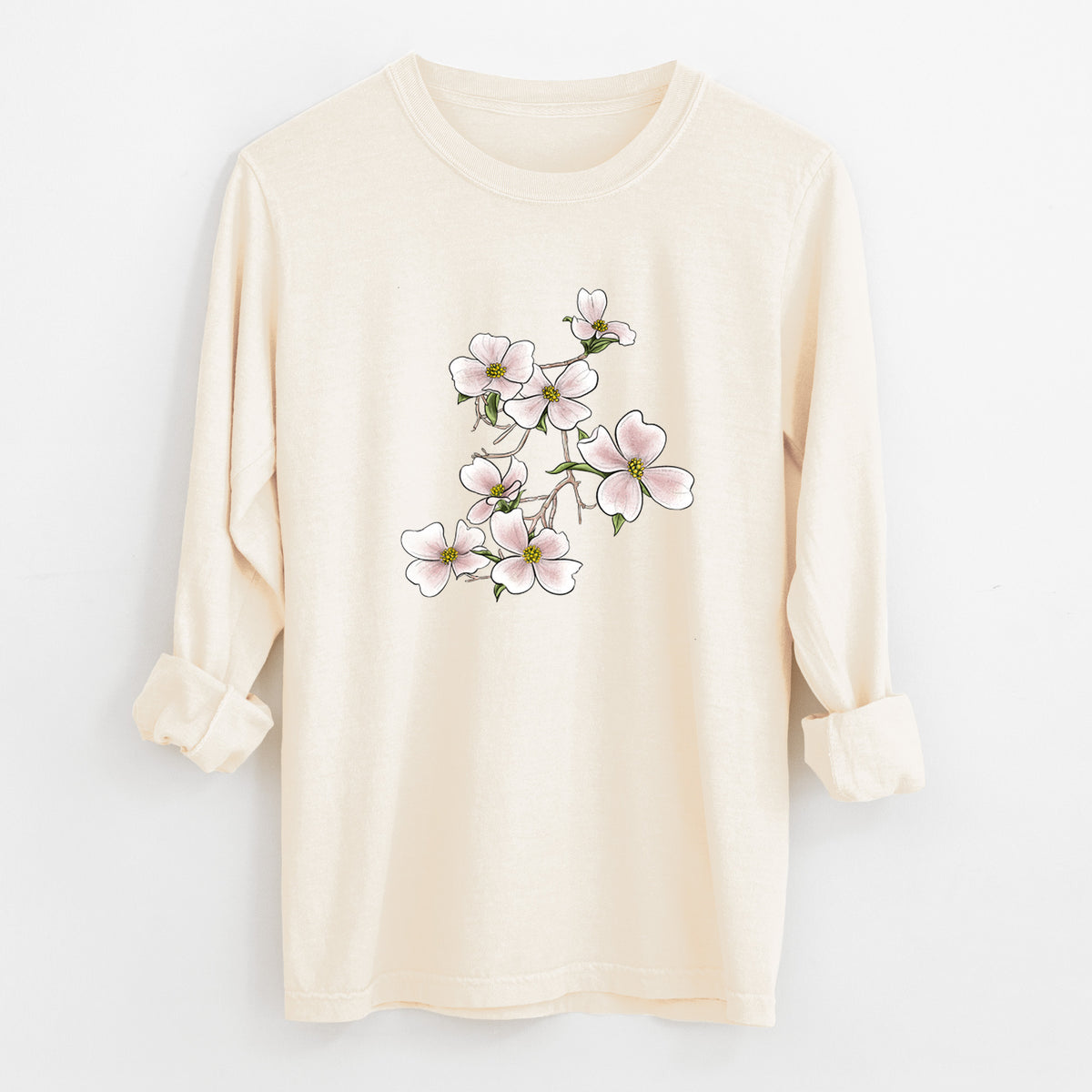 Ivory Comfort Colors long sleeve shirt laid flat with the cuffs rolled, printed with a full-color illustration of pink and white dogwood blossoms on a branch.