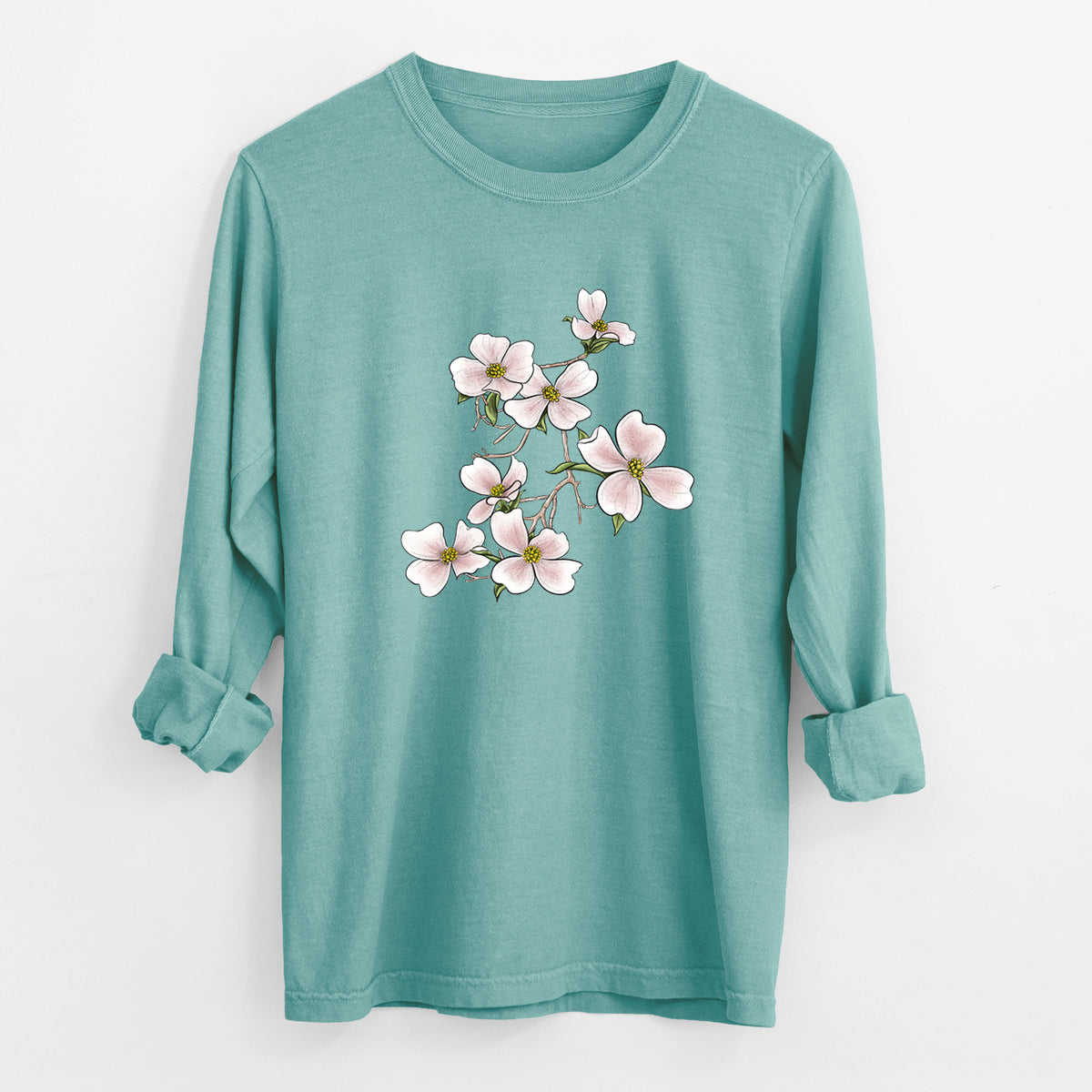Reef green Comfort Colors long sleeve shirt laid flat with the cuffs rolled, printed with a full-color illustration of pink and white dogwood blossoms on a branch.