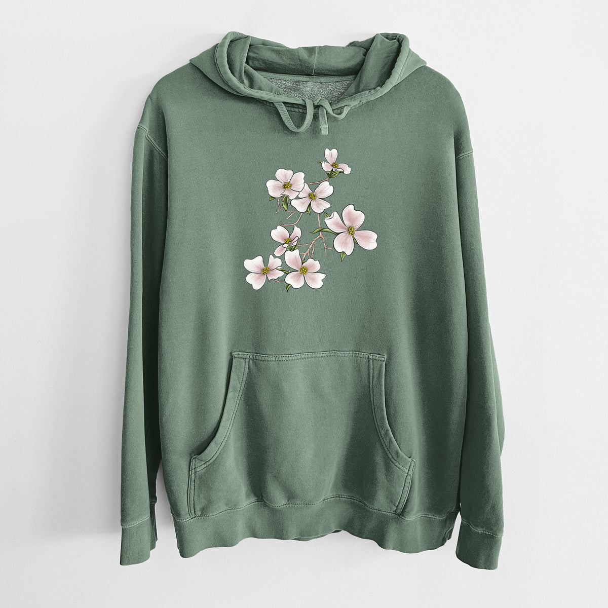 Alpine green pigment dyed hoodie laid flat, printed with a full-color illustration of pink and white dogwood blossoms on a branch.