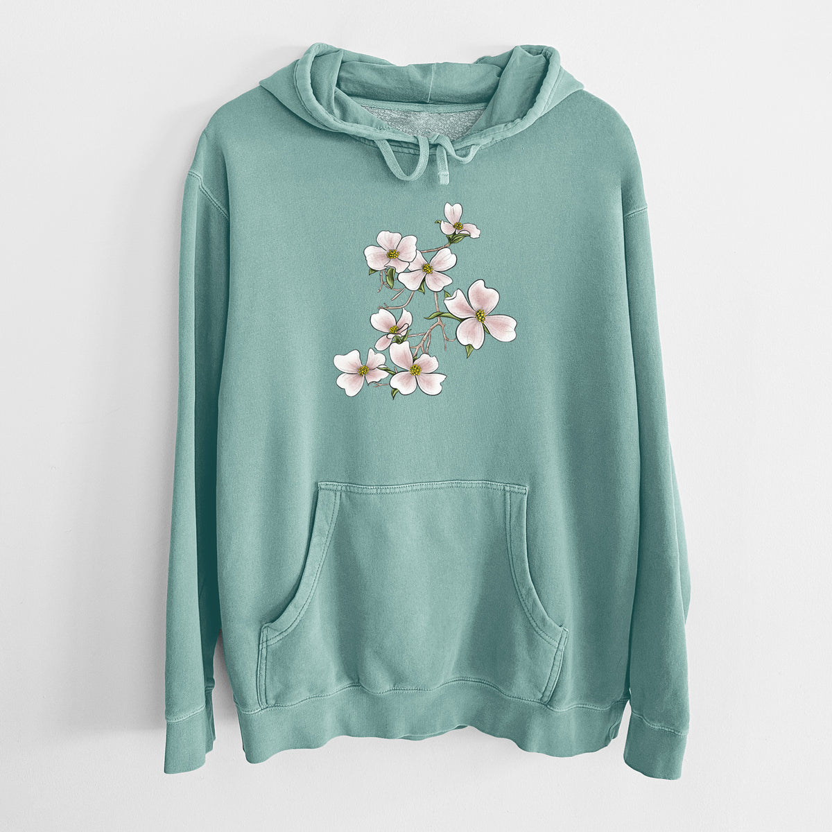 Mint green pigment dyed hoodie laid flat, printed with a full-color illustration of pink and white dogwood blossoms on a branch.