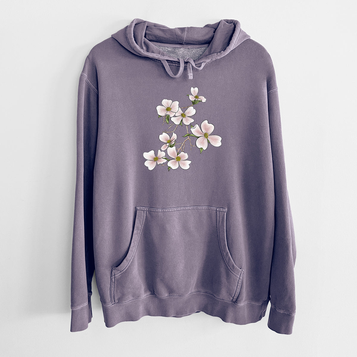 Plum purple pigment dyed hoodie laid flat, printed with a full-color illustration of pink and white dogwood blossoms on a branch.